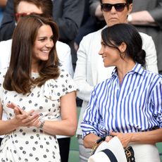 Catherine, Duchess of Cambridge and Meghan, Duchess of Sussex attend day twelve of the Wimbledon Tennis Championships at the All England Lawn Tennis and Croquet Club on July 14, 2018 in London, England.