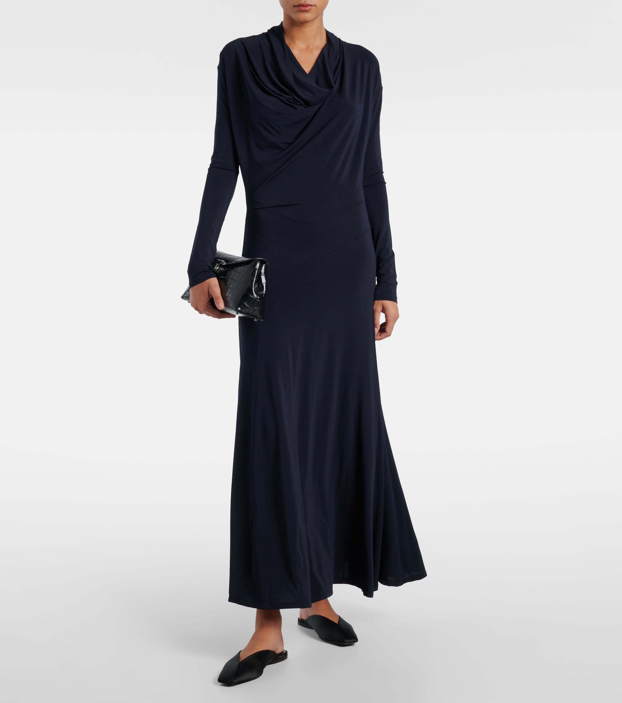 a model wearing a navy jersey work dress from tove