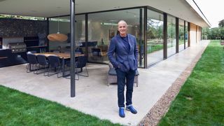 Kevin McCloud outside a new build home