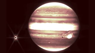 Jupiter and its moon Europa, left, are seen through the James Webb Space Telescope's NIRCam instrument 2.12 micron filter.