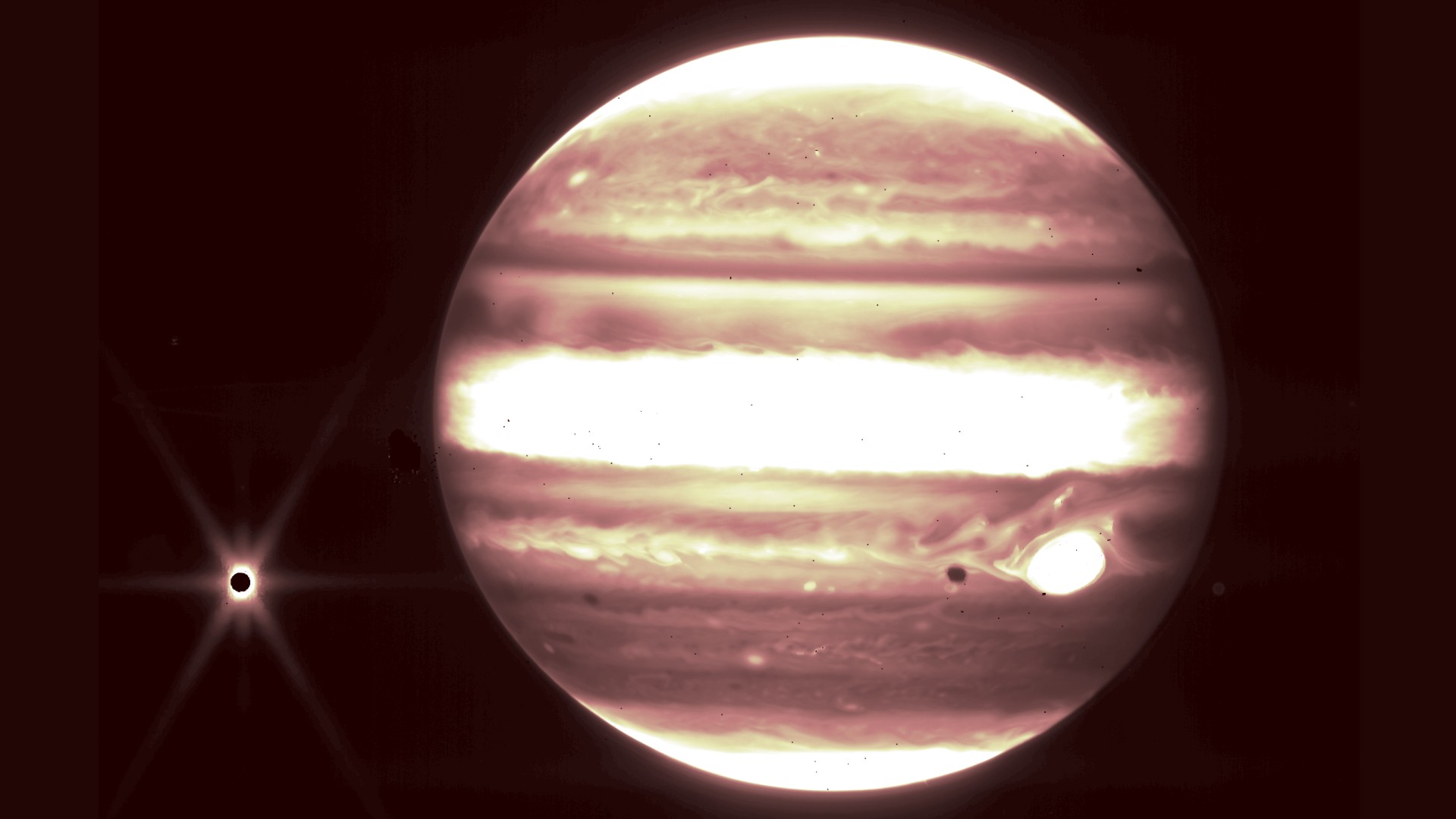 Jupiter and its moon Europa, left, are seen through the James Webb Space Telescope’s NIRCam instrument 2.12 micron filter.
