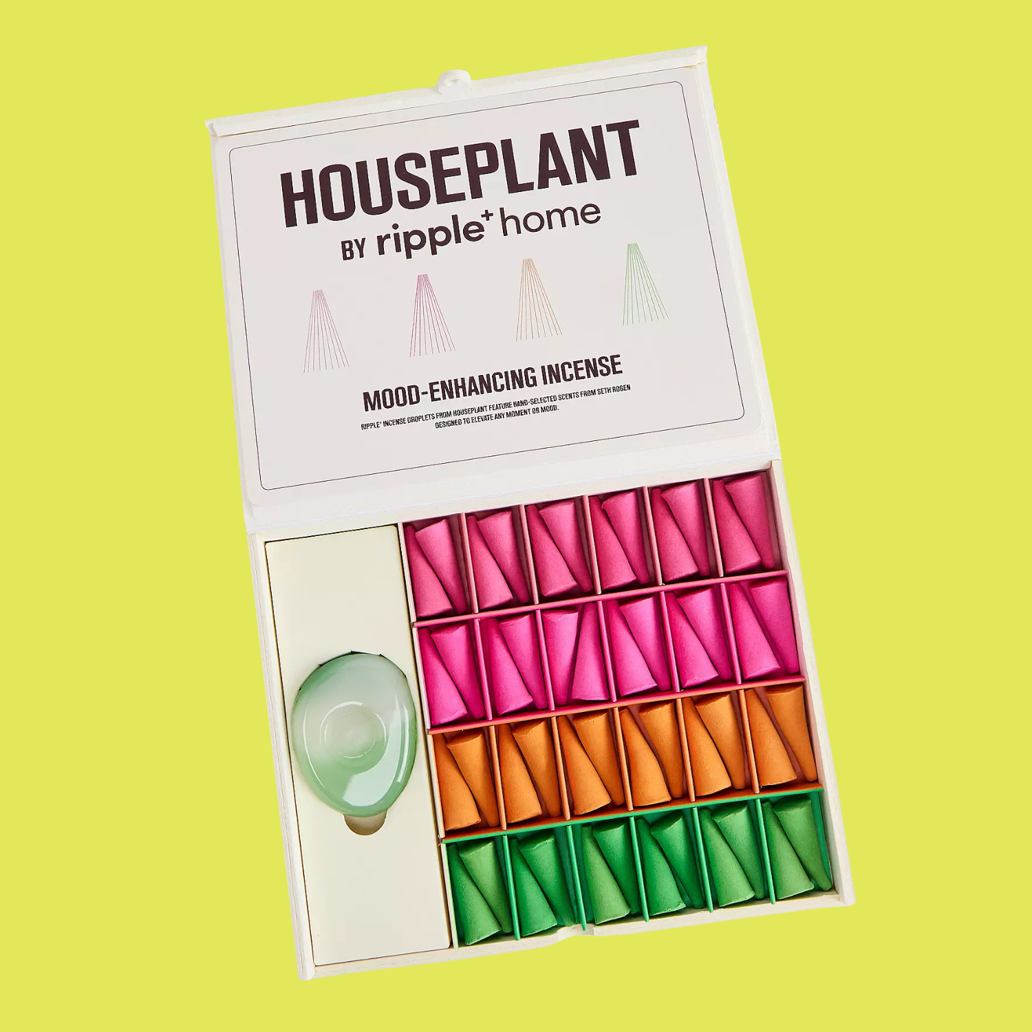 A box of colorful incense cones and a sea glass holder