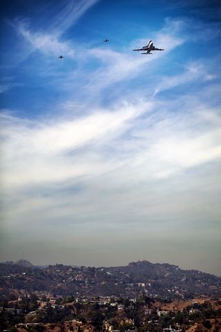 Photographer Olivia Hemaratanatorn captured this view of space shuttle Endeavour soaring over the famed Hollywood sign during its low flyover of Los Angeles on Sept. 21, 2012.
