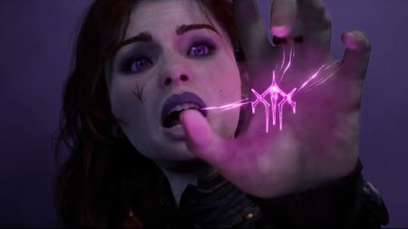Warlock character holding a purple magic rune