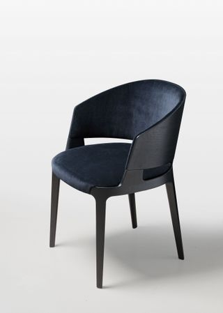 Dining chair with blue velvet upholstery and hard wooden back