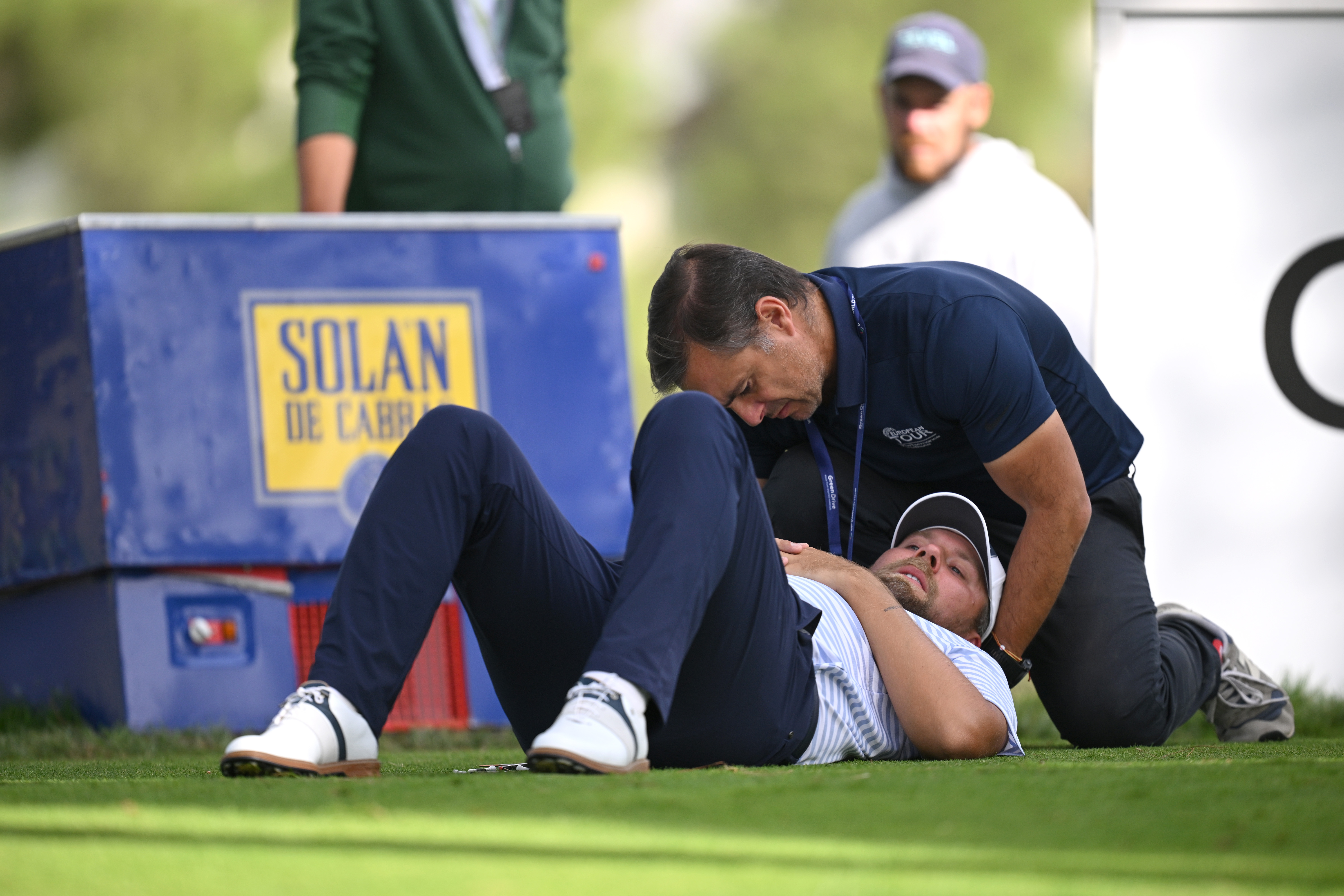 Dan Brown receives treatment from a DP World Tour physio during the final round of the 2025 Open de Espa&amp;ntilde;a