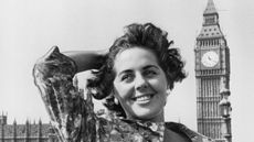 black and white photo of young Boothroyd with her hand in her hair in front of Big Ben