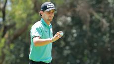 Joaquin Niemann acknowledges the crowd after holing a putt in a LIV Golf tournament