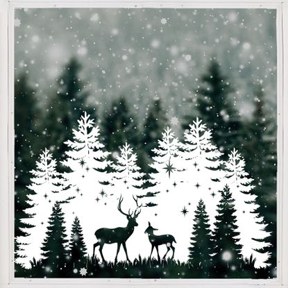 christmas window painted with a snowy forest scene and stags