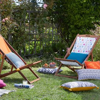 relaxing chairs with patterned cushions in garden