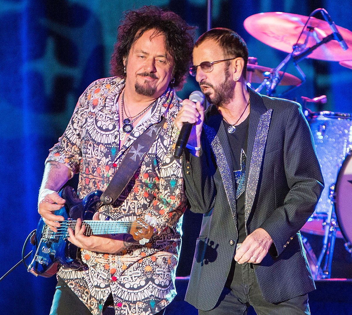 PALA, CA - MARCH 14: Musicians Steve⁣ Lukather (L) and Ringo Starr perform on stage with ⁢Ringo Starr & his All-Starr ​Band ‌at ⁢Pala Casino on March‍ 14, ‍2015‌ in Pala, ​California.
