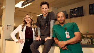 Sarah Chalke, Zach Braff, and Donald Faison posing for the Scrubs reboot.