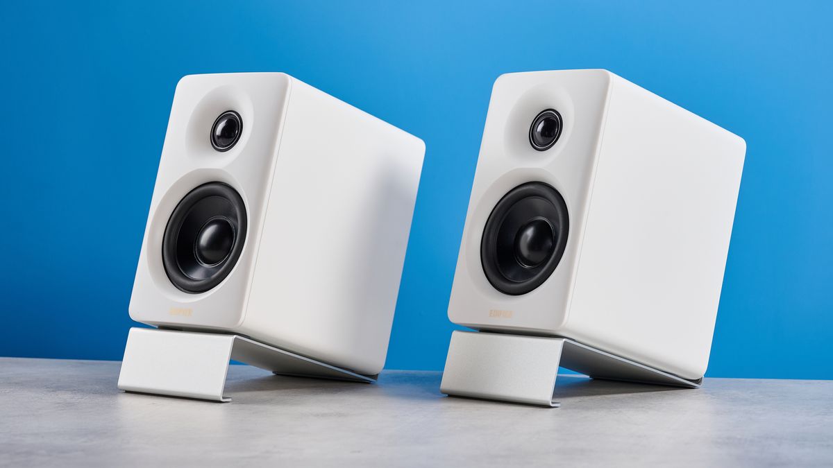 the edifier m60 bookshelf speakers in white photographed against the blue tom's guide background