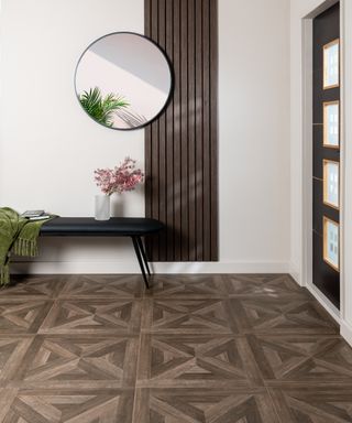 Hallway with parquet floor, bench and white wall with tall panel and mirror