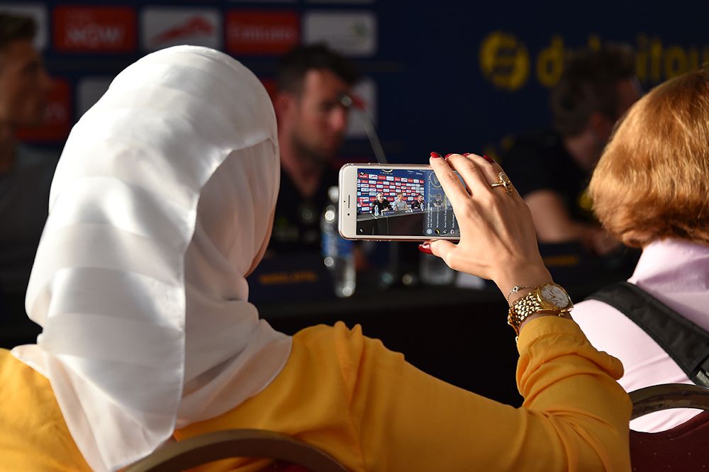 An audience memberr captures a photo at the Dubai Tour press conference