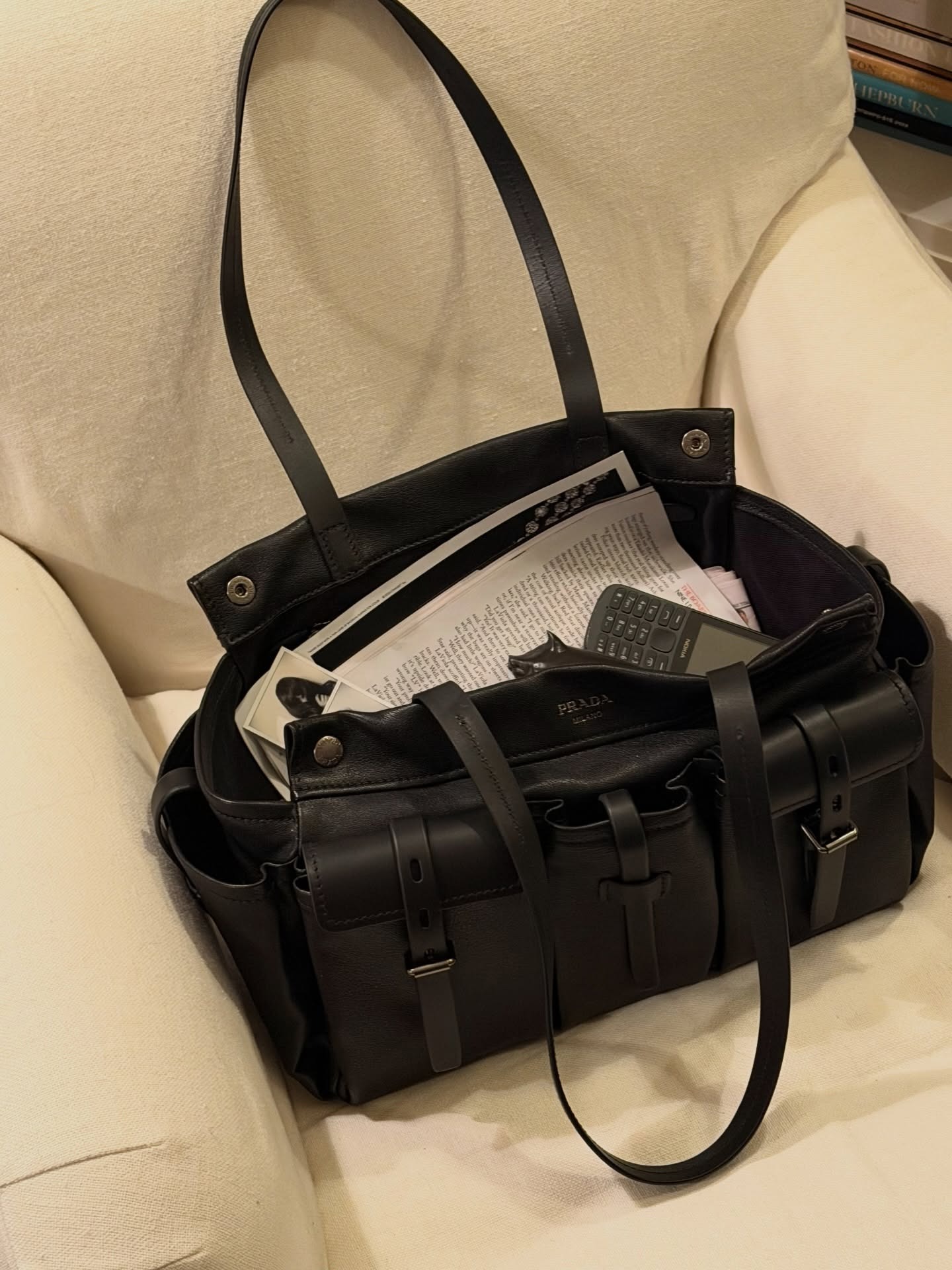 Alexa Chung's Prada Route bag with papers and an old phone inside.