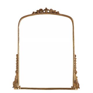 A gold mirror with ornate detailing