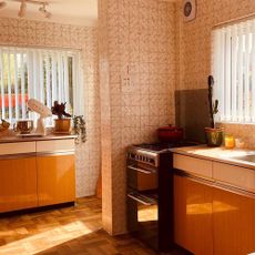seventies style kitchen with wooden cabinets