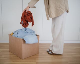 Woman throwing clothes in boxes