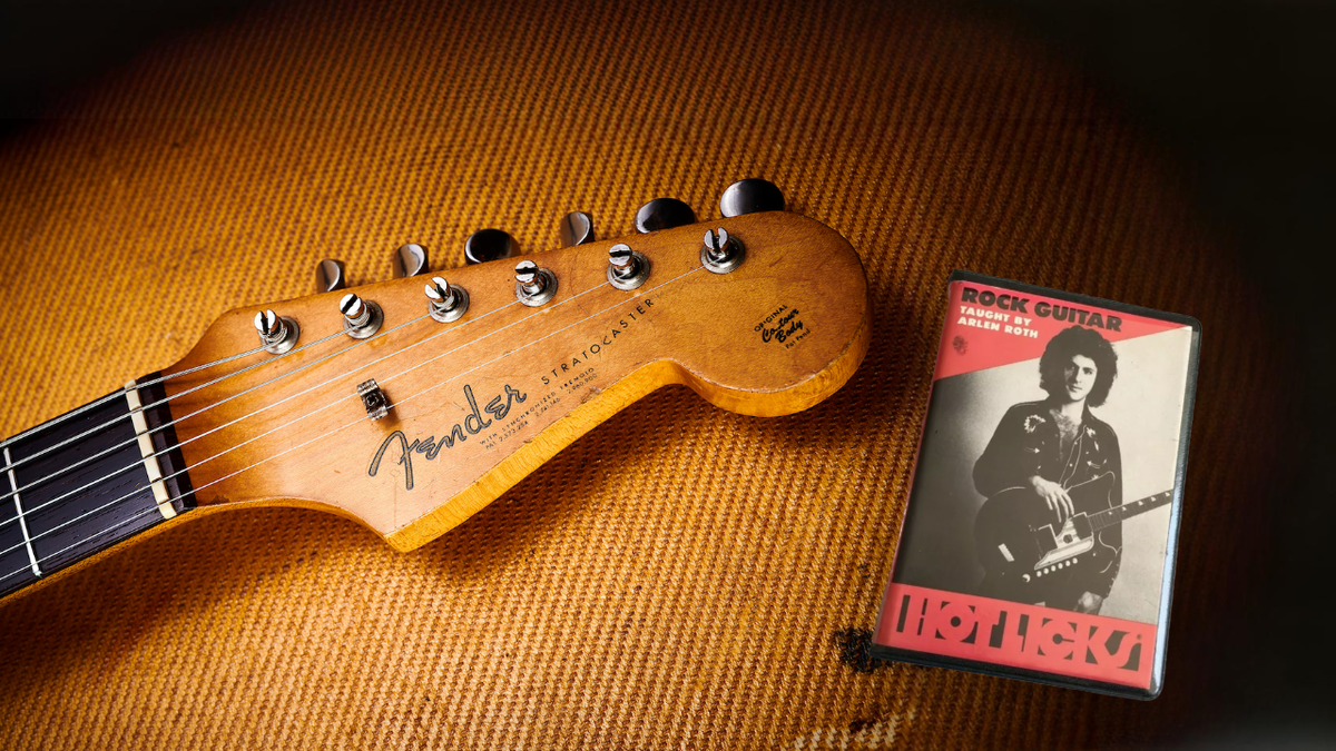 A stratocaster headstock next to a cassette of Arlen Roth&#039;s Rock Guitar