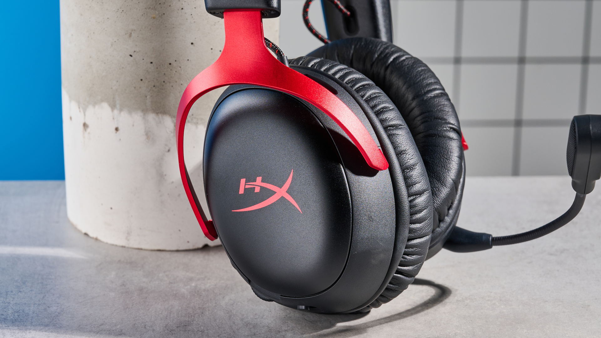 A black and red HyperX Cloud III S Wireless gaming headset