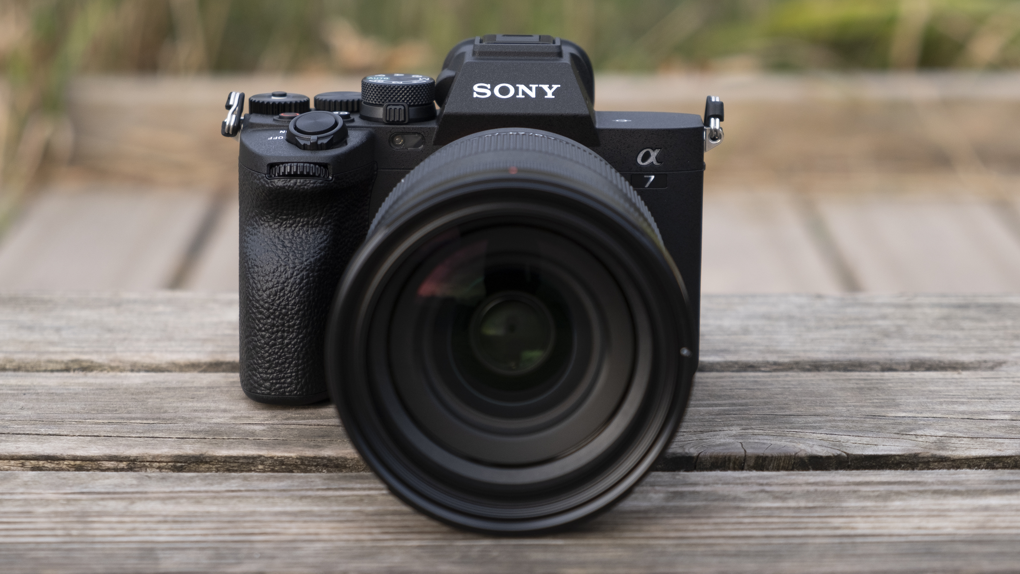 The front of the Sony A7 IV camera on a bench