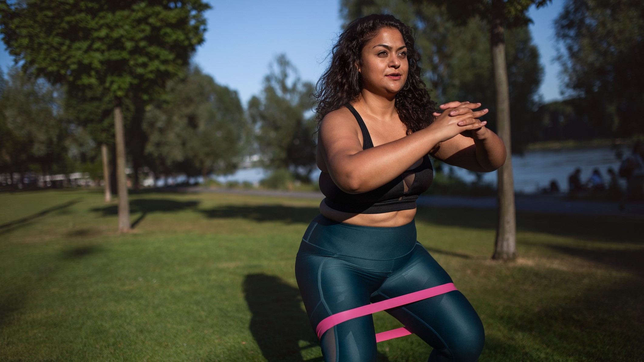 a woman doing resistance band squats