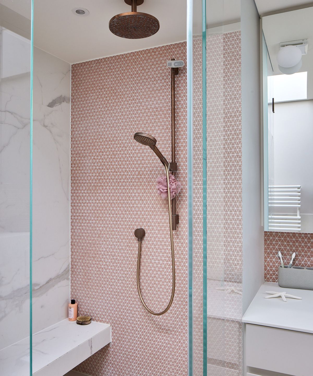 pink tiled shower en suite bathroom with brass fixtures