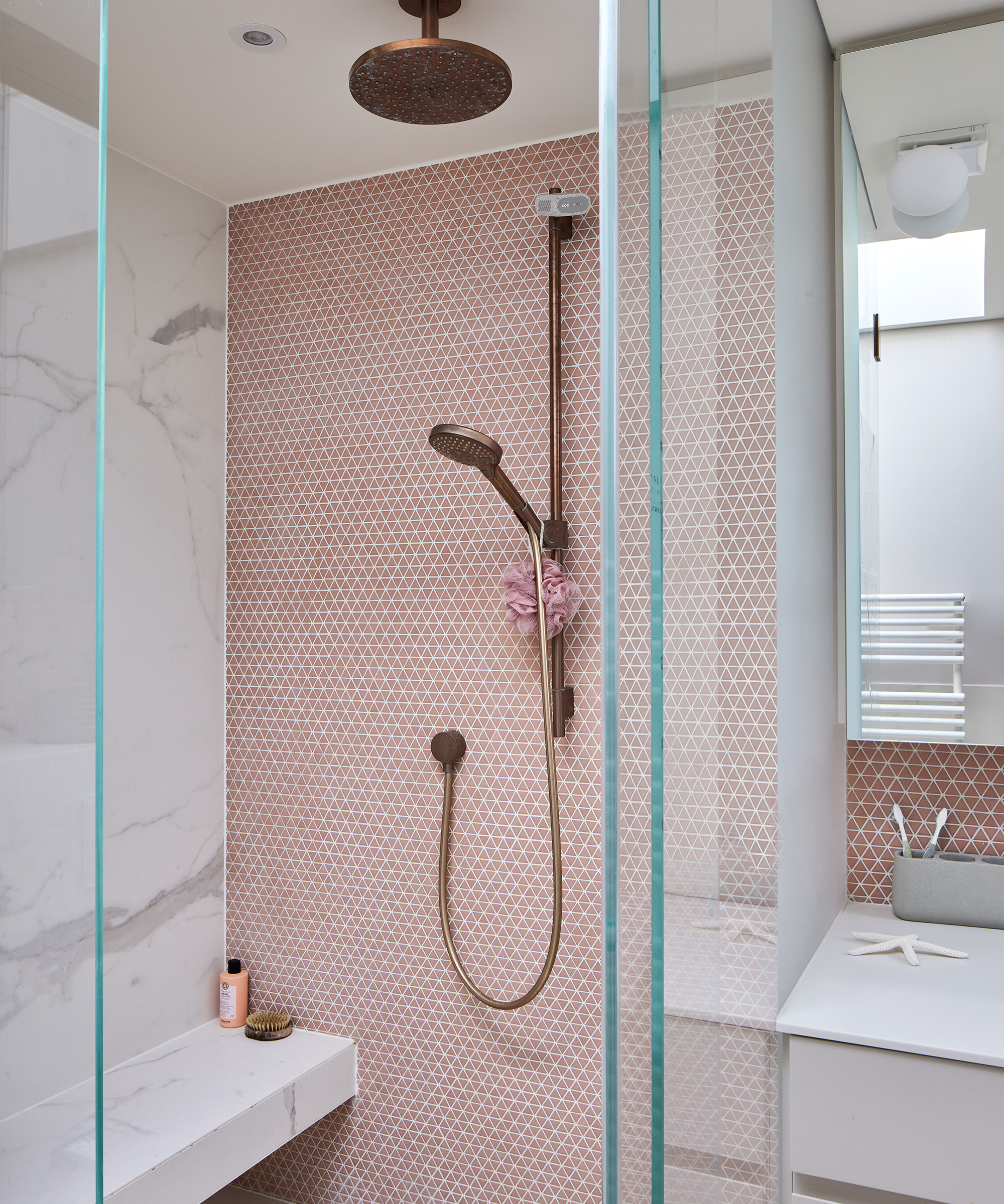 pink tiled shower en suite bathroom with brass fixtures