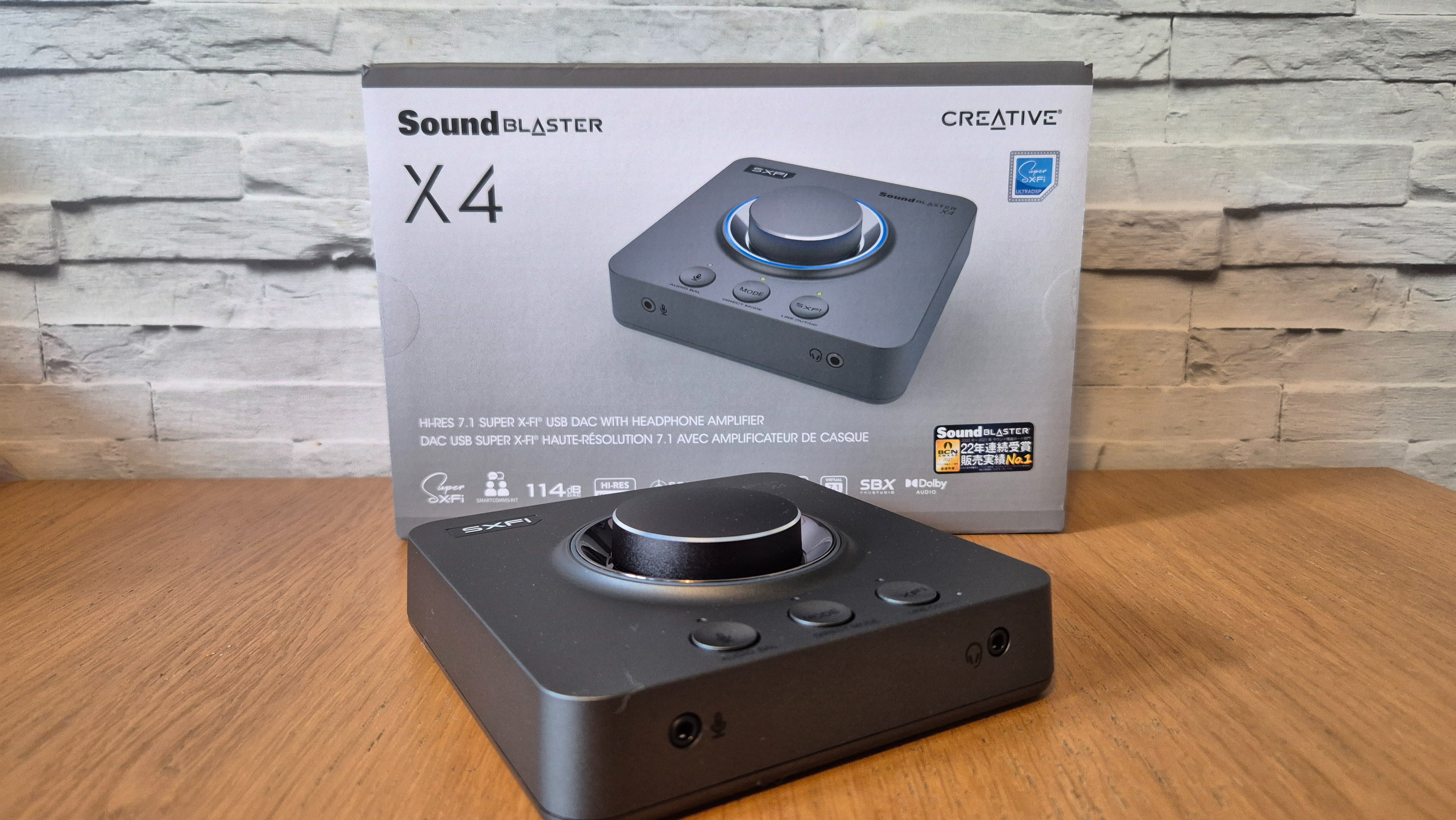 The Creative Sound Blaster X4 USB sound card on a wooden surface