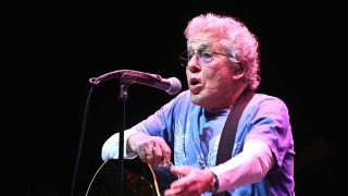 Roger Daltrey onstage with an acoustic guitar