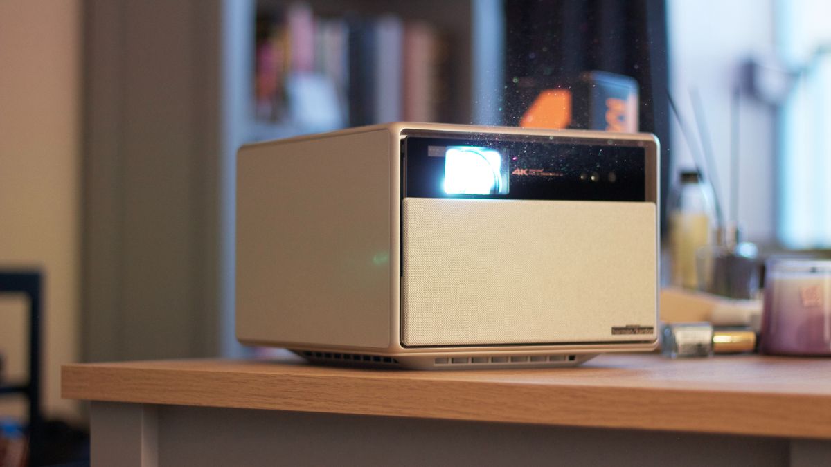 A square white projector on a beach coffee table