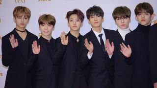 Jun, Dino, Hoshi, Wonwoo, Vernon and S.Coups of SEVENTEEN in black evening suits.
