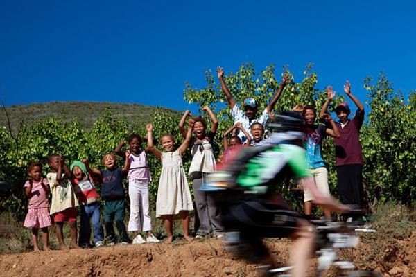 Riders are encouraged by local school children