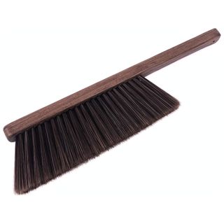 A soft-bristled handheld brown wooden broom brush with brown bristles