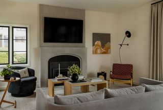 living room with beige sofa and warm white walls with fireplace
