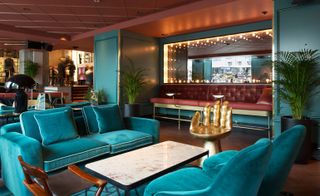 Bright blue seating area and gold hand chair in lobby