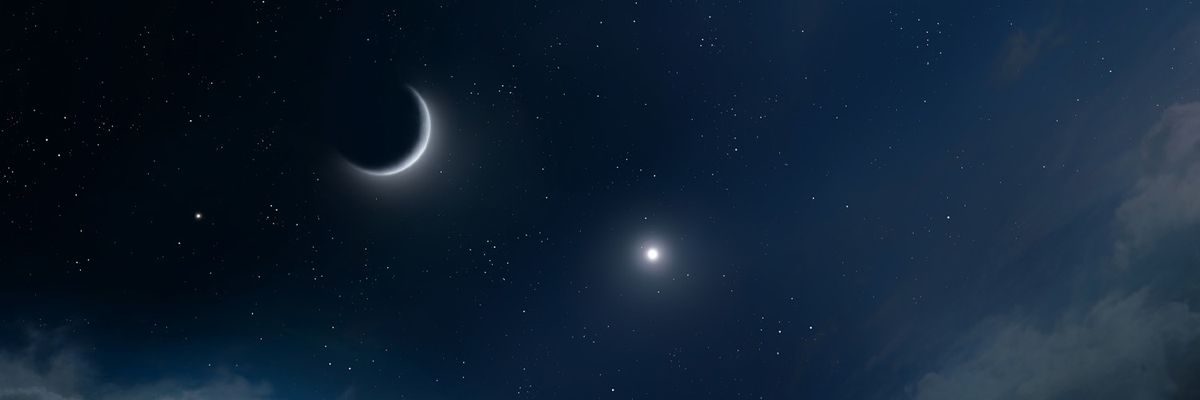 crescent moon and planet in the night sky
