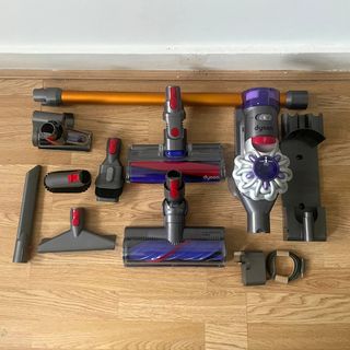 Dyson V8 Absolute components sitting on hardwood floors