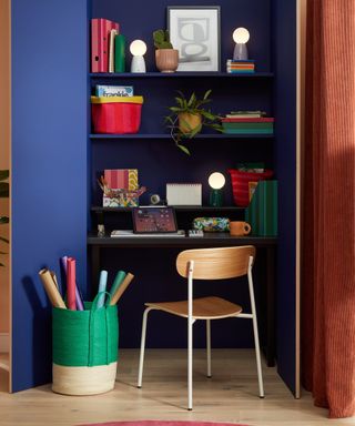 Small home office with chair, desk and shelving above