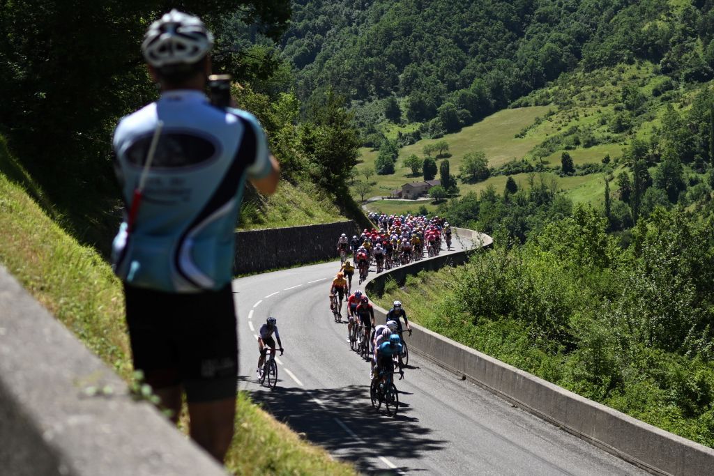The pack ridesduring the sixth stage of the 74th edition of the Criterium du Dauphine cycling race 1965 km between Rives and Gap central eastern France on June 10 2022 Photo by Marco BERTORELLO AFP Photo by MARCO BERTORELLOAFP via Getty Images