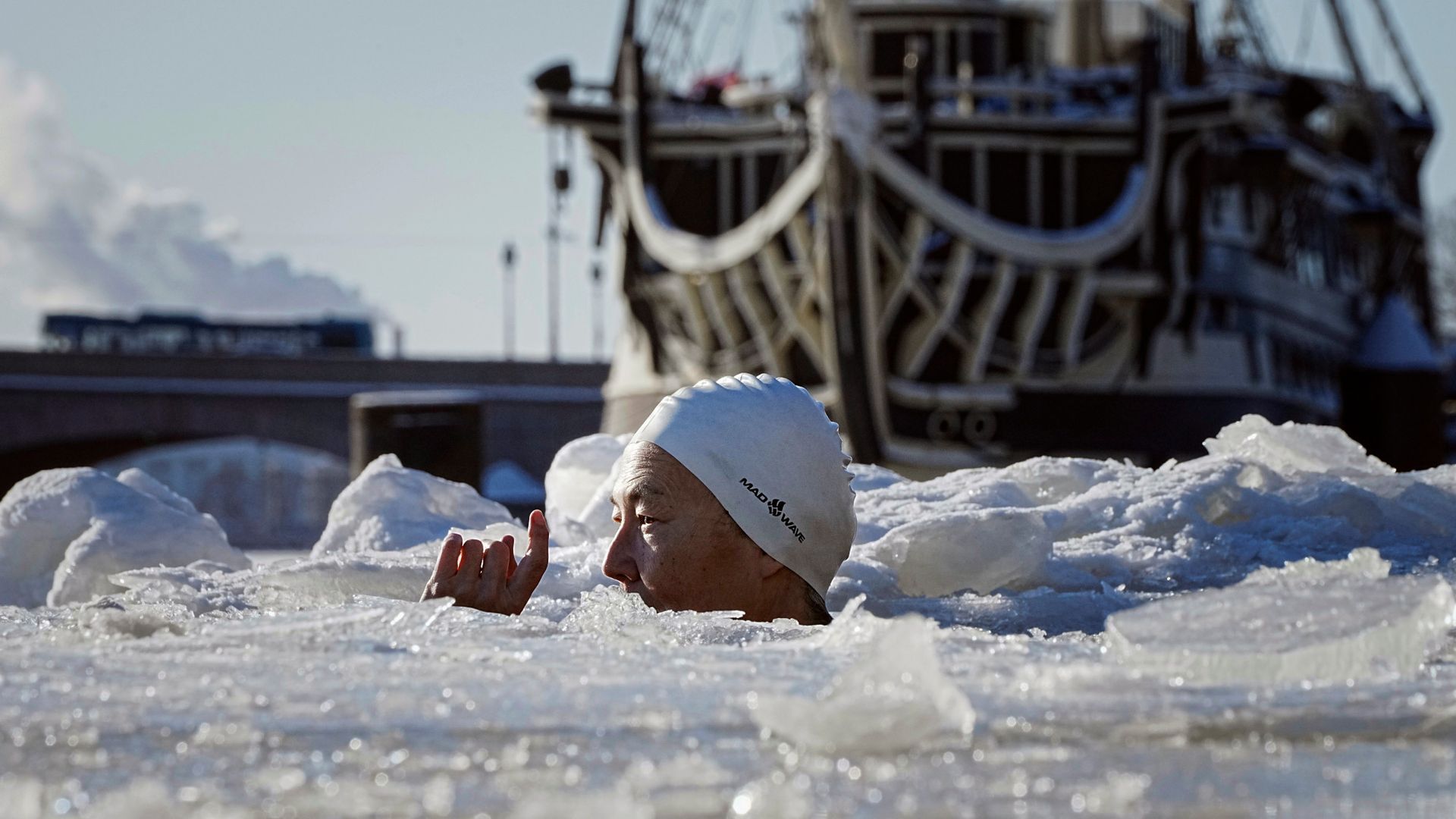 
                                A woman plunges into the icy waters of the Neva River in Russia
                            