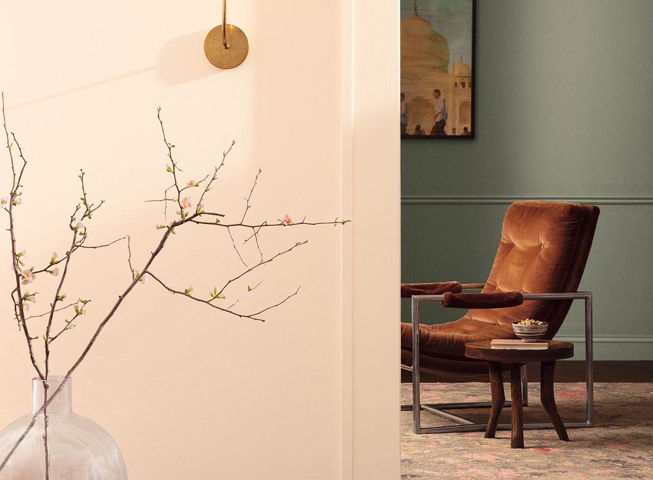 The view of a room with a leather shade, with the foreground walls painted a neutral shade and the other room painted a green shade