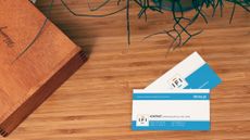 A pair of business cards on a desk.