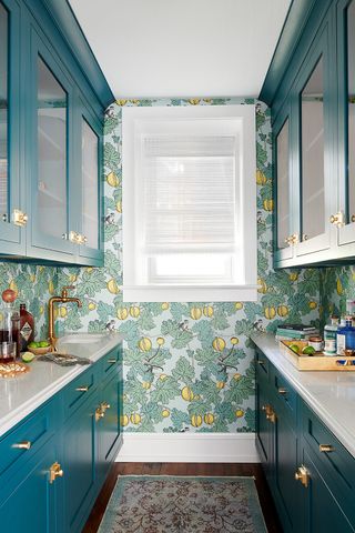 Small blue kitchen with Cole & Son wallpaper