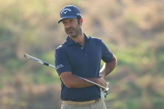 Jorge Campillo on the putting green lining up a putt