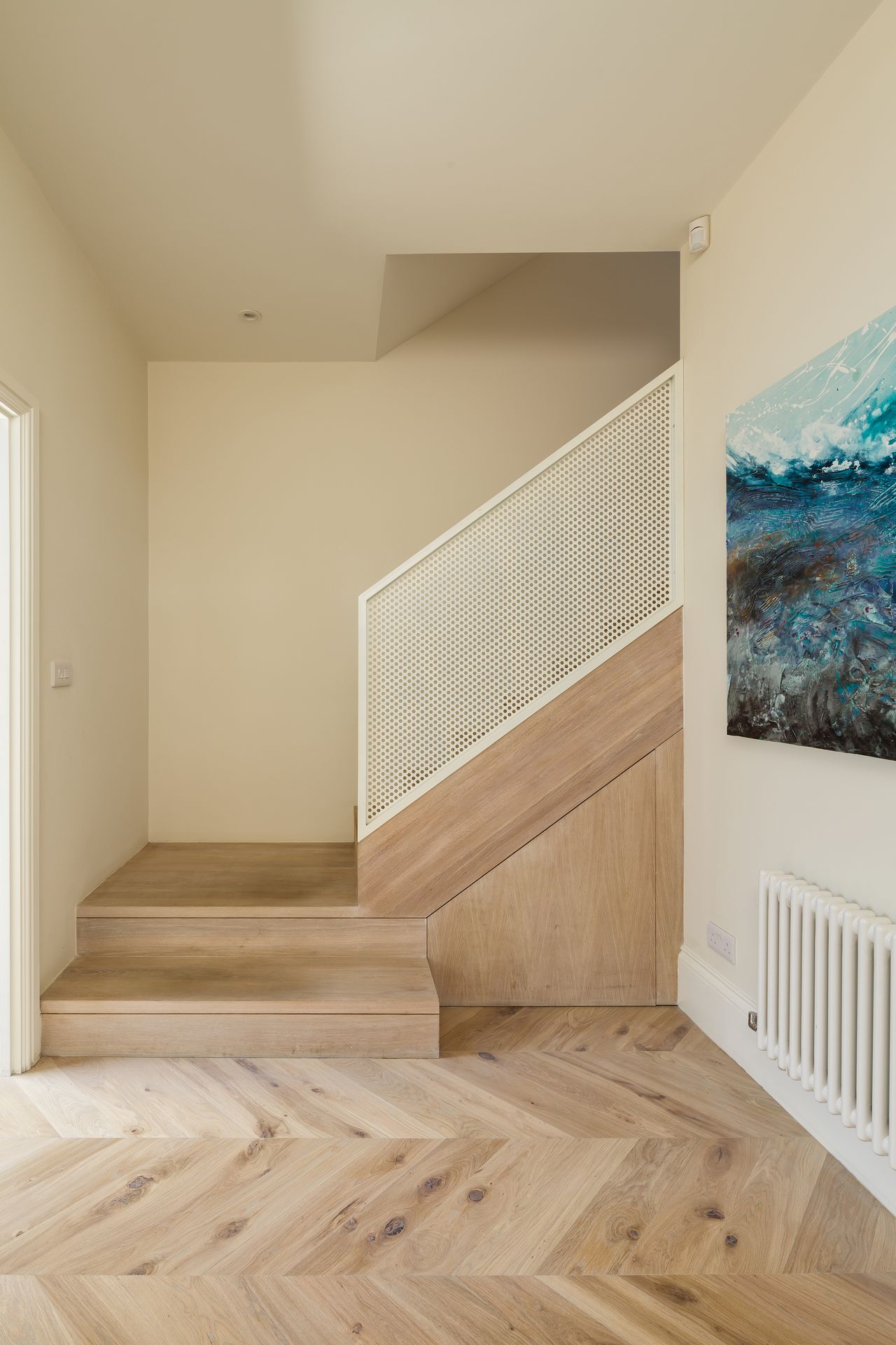 staircase with wood flooring and white handrail