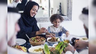 A Middle Eastern family eating dinner.