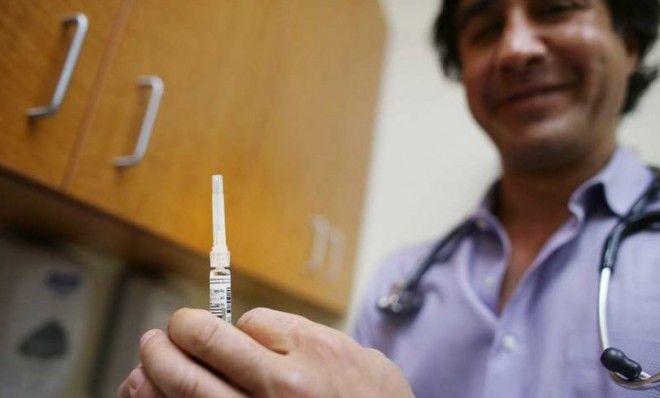 A doctor prepares to give the flu vaccine to a New Yorker in a walk-in clinic on Jan. 10.