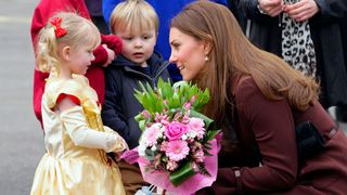 Kate Middleton with a young fan dressed in a Princess costume